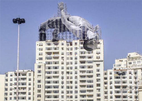 ▲ JR的装置艺术在里约市内某居民楼顶，图片来源：艺术家本人的instagram